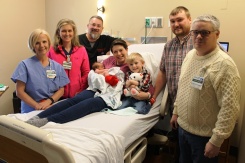 Zacharias, Emily, Nathanael and Patrick Rhodes. Left of bed and far right of bed: Debbie Reese, RN, Harton’s Women’s Center; Ginny Barton, MD; H. Mather Bennett, MD and Scott Hays, DO